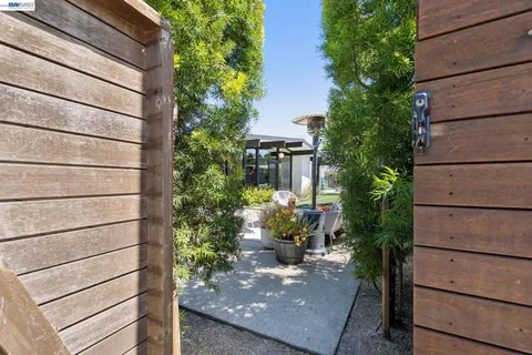 a view of swimming pool with outdoor seating and a garden