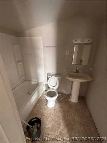 a living room with furniture window and a wooden floor