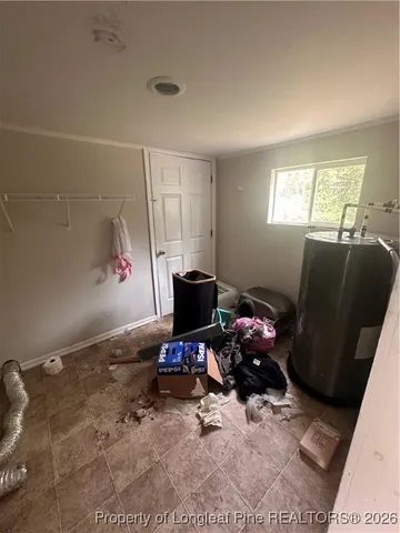 a living room with furniture a flat screen tv and a dresser