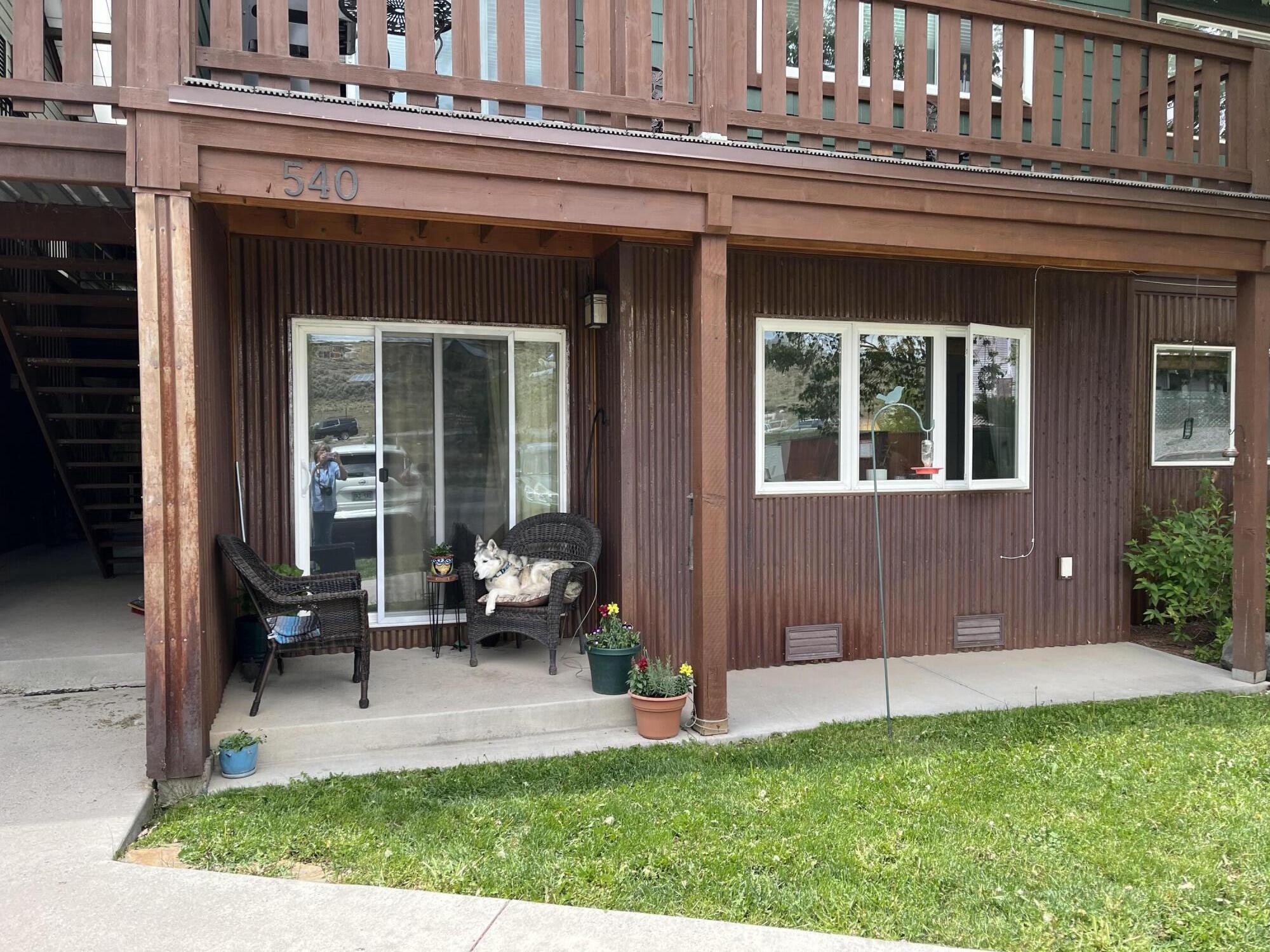 540 Redcliff Circle, Unit E104 Ridgway, CO 81432 - Photo 2 of 15 a view of a house with a patio and a yard