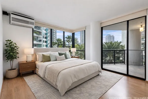 a bedroom with a large bed and a potted plant