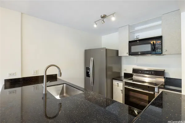 a kitchen with a refrigerator and a microwave