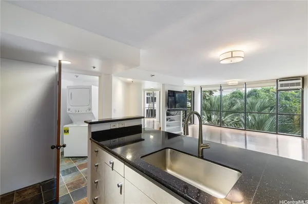 a kitchen with granite countertop a sink and a counter top space