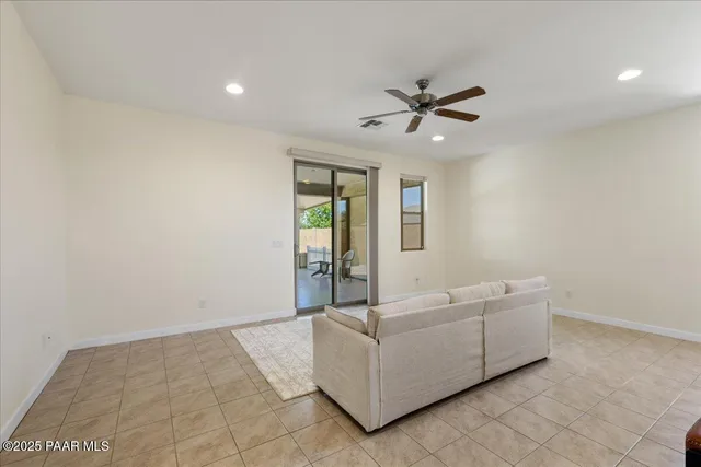 a living room with furniture and a ceiling fan