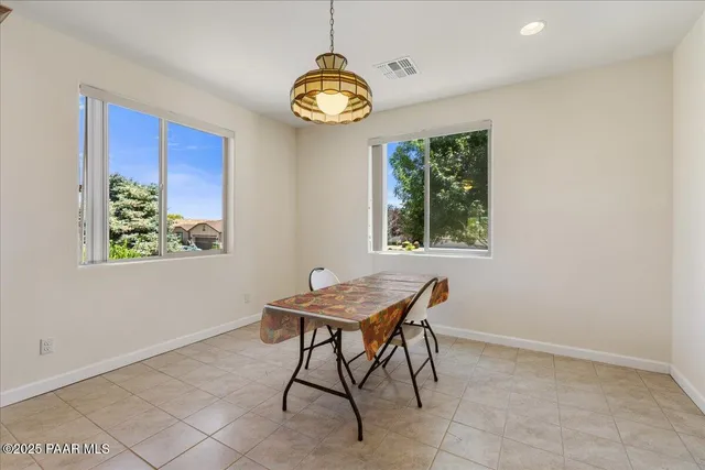 a dining room with a table and chairs