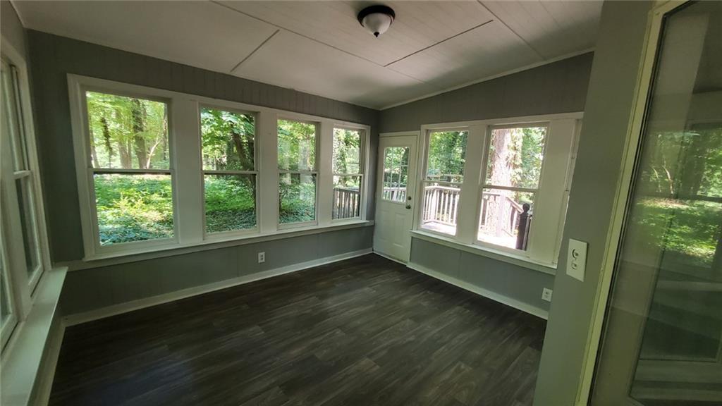 209 Mill Ridge Court Lawrenceville, GA 30046 - Photo 6 of 11 a view of an empty room with wooden floor and a window