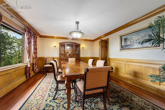 13 Pine Road Colorado Springs, CO 80906 - Photo 7 of 41 Dining area featuring ornamental molding and wood-type flooring