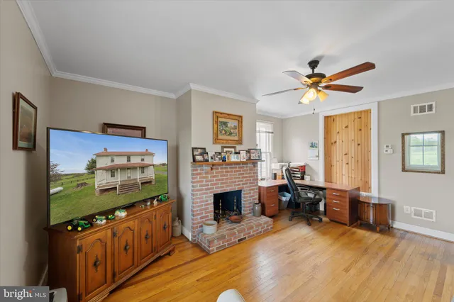 a living room with furniture flat screen tv and a fireplace