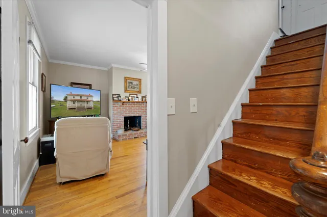 a view of entryway and hall with wooden floor