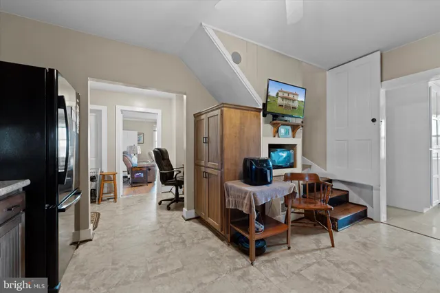 a living room with furniture gym equipment and a large window