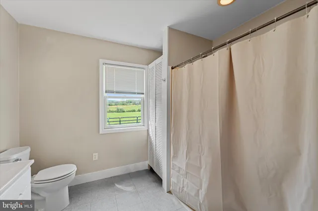 a bathroom with a shower curtain and a toilet