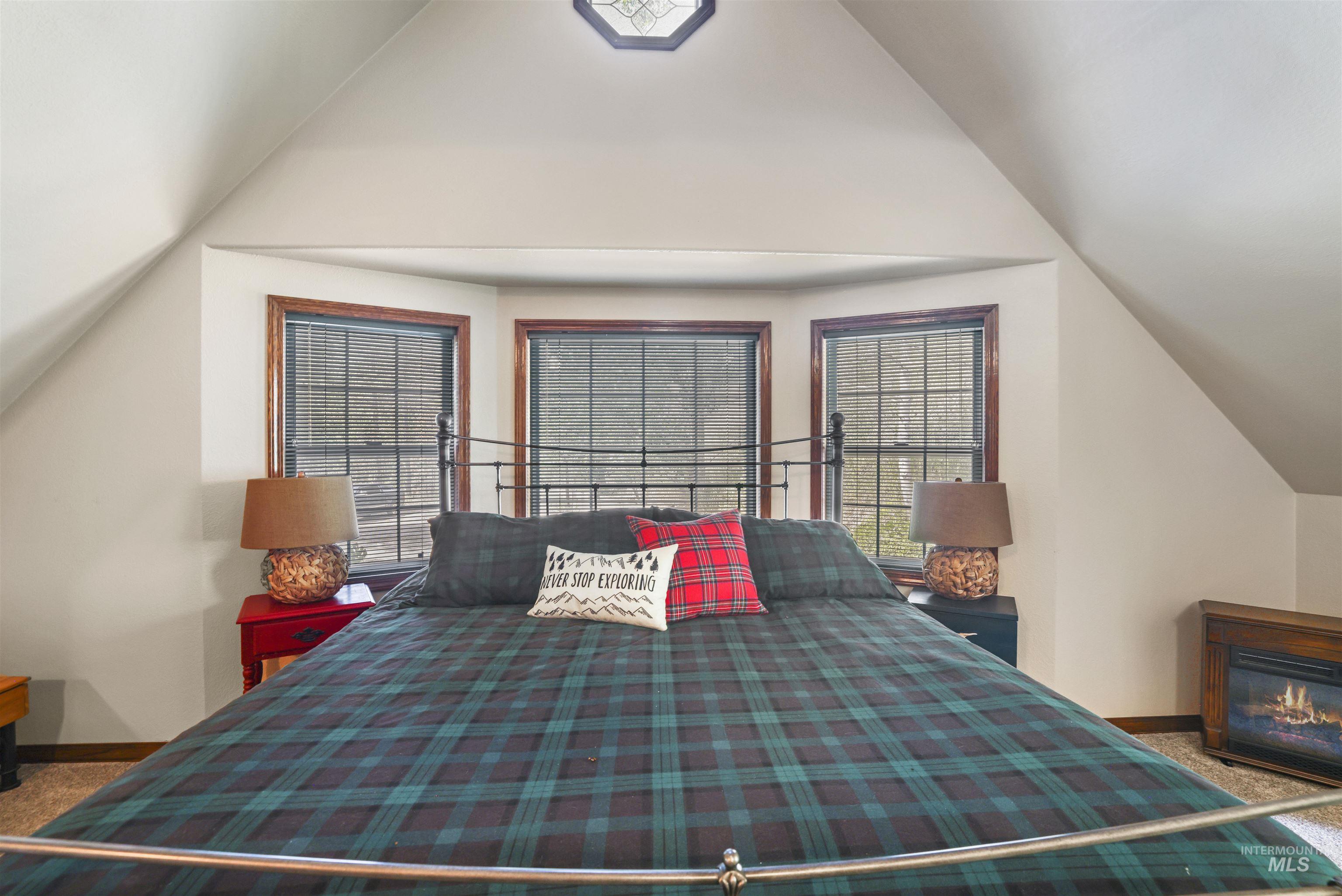 224 Dakota Road Mountain Home, ID 83647 - Photo 28 of 50 Vaulted ceiling bedroom featuring a three-panel bay window with dark wood trim