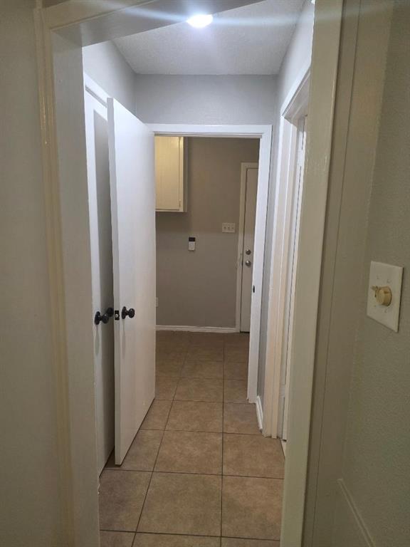 Undisclosed Address Hurst, TX 76054 - Photo 18 of 29 HALLWAY ON OPPOSITE SIDE OF HOME FROM KITCHEN TO 3RD BEDROOM AND UTILITY ROOM