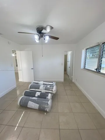 a living room with furniture and a ceiling fan