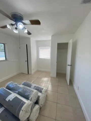 a living room with furniture and a ceiling fan