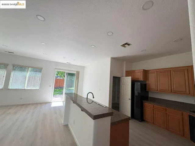a kitchen with stainless steel appliances granite countertop a refrigerator sink and cabinets