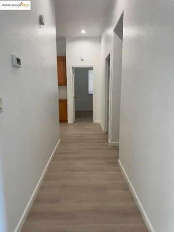 a view of a hallway with wooden floor