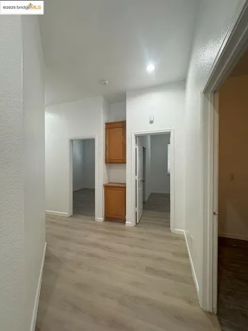a view of a hallway with wooden floor