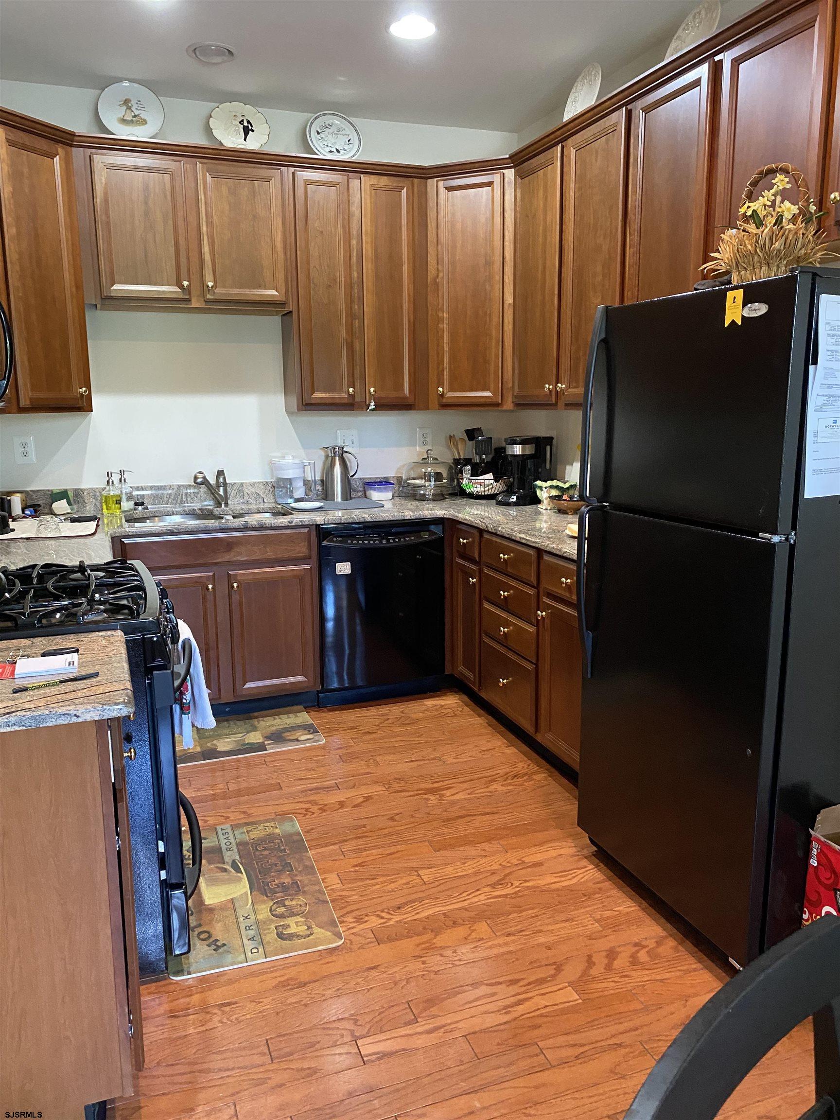 2 Old Mill Drive, Unit 2 Voorhees, NJ 08043 - Photo 8 of 20 a kitchen with kitchen island granite countertop a refrigerator stove top oven and sink