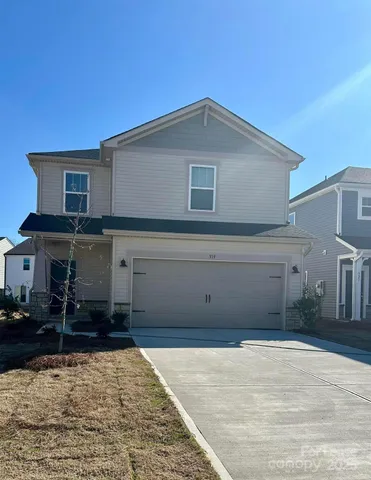 a front view of a house with garage