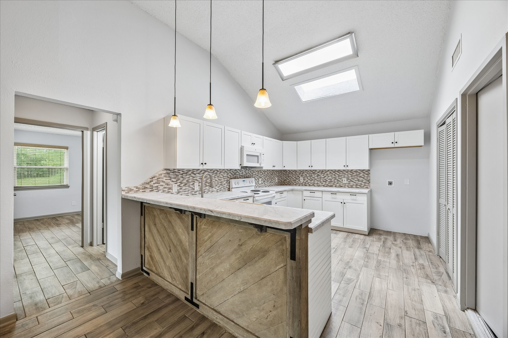 206 Lockett Street Brenham, TX 77833 - Photo 4 of 12 a kitchen with a sink a counter space and wooden floor