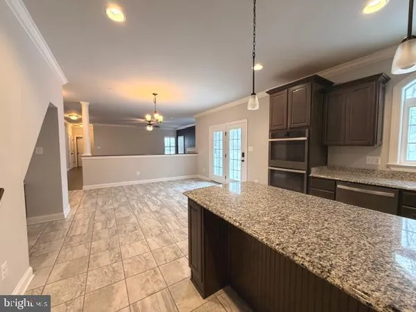 a bathroom with a granite countertop sink and a large mirror