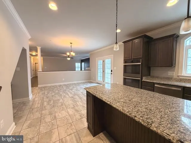 a bathroom with a granite countertop sink and a large mirror