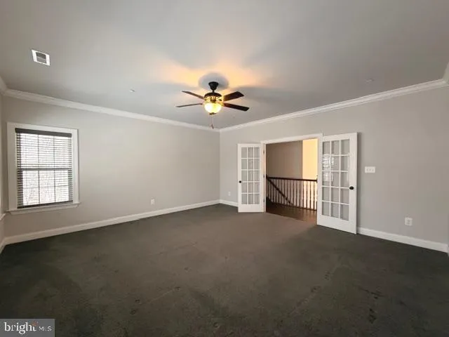 an empty room with closet and windows