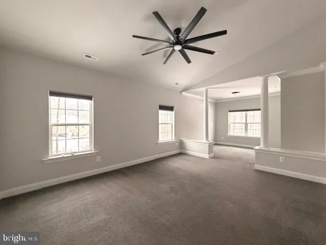 a view of a livingroom with a ceiling fan and window