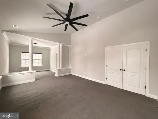 a view of a livingroom with a ceiling fan and window