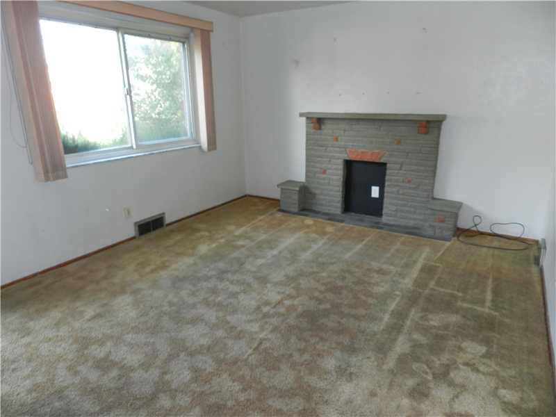 428 Grove Road Verona, PA 15147 - Photo 4 of 15 Living Room. This living room has a large window that lets in great natural light, and a stone decorative fireplace as a focal statement.