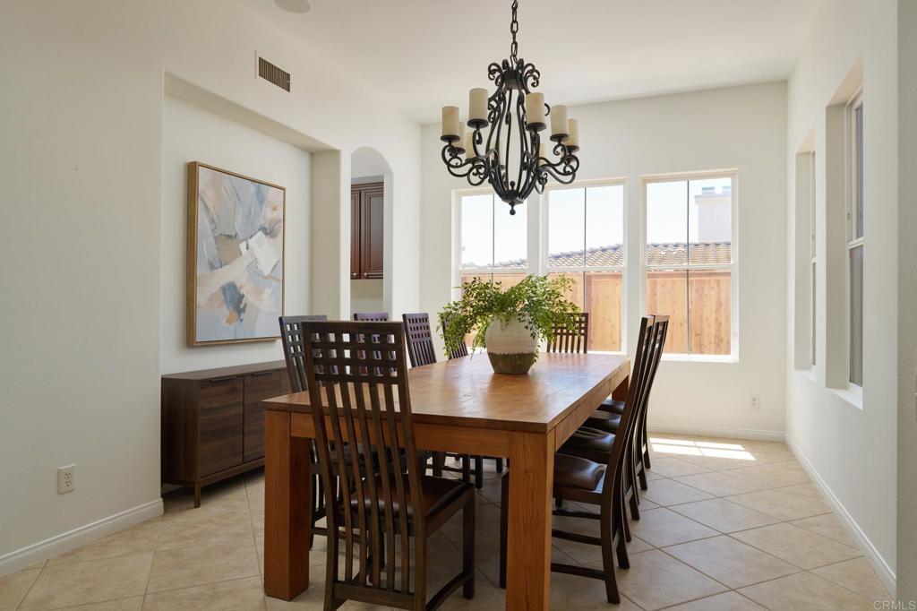 835 Stratford Knoll Encinitas, CA 92024 - Photo 11 of 31 a view of a dining room with furniture window and wooden floor