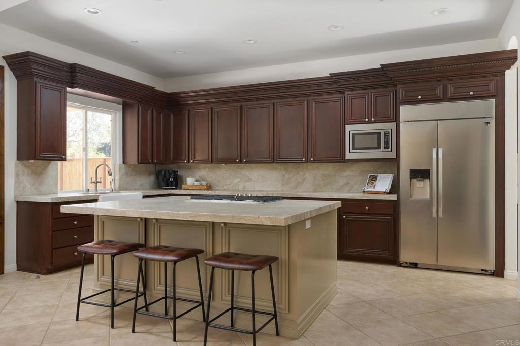 835 Stratford Knoll Encinitas, CA 92024 - Photo 12 of 31 a kitchen with a sink cabinets and stainless steel appliances
