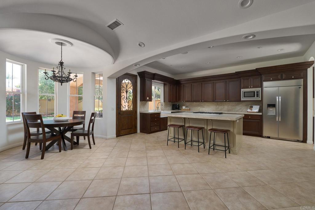 835 Stratford Knoll Encinitas, CA 92024 - Photo 13 of 31 a view of a dining area with furniture and chandelier