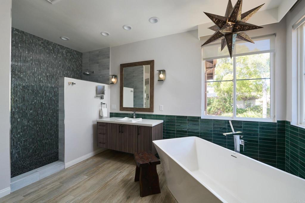 835 Stratford Knoll Encinitas, CA 92024 - Photo 20 of 31 a kitchen with a sink a window and stainless steel appliances