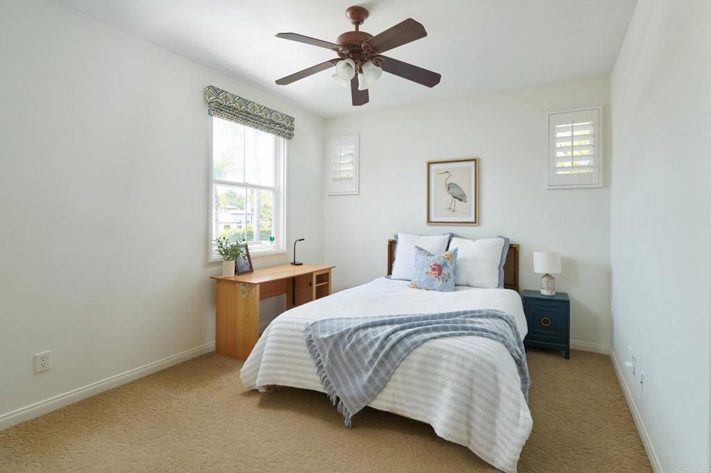 835 Stratford Knoll Encinitas, CA 92024 - Photo 21 of 31 a bedroom with a bed and window