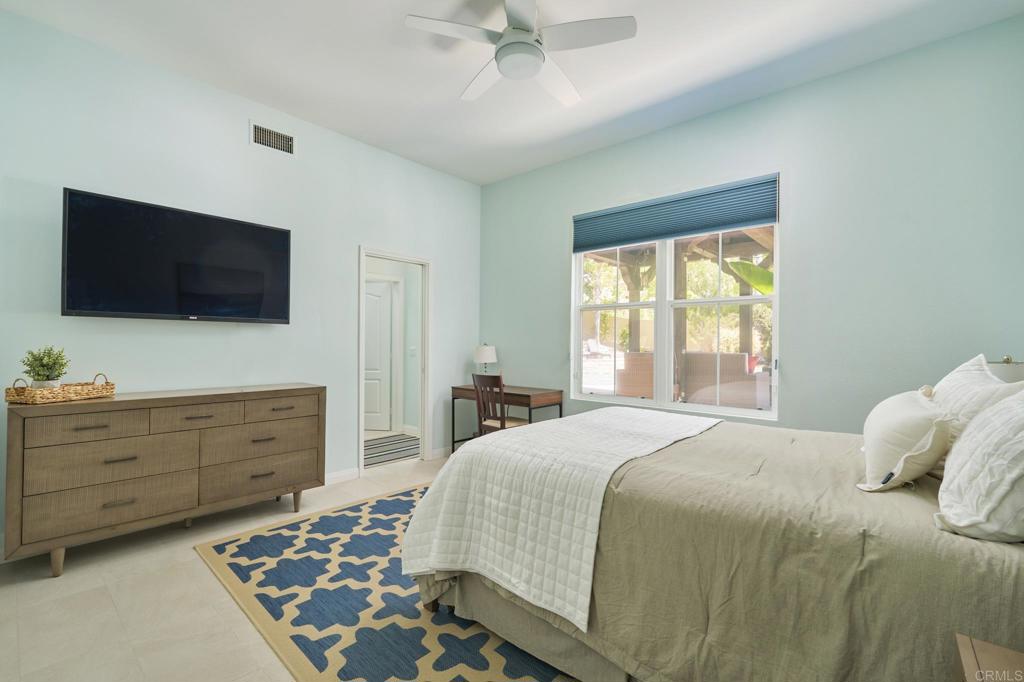 835 Stratford Knoll Encinitas, CA 92024 - Photo 25 of 31 a bedroom with a bed and a flat screen tv
