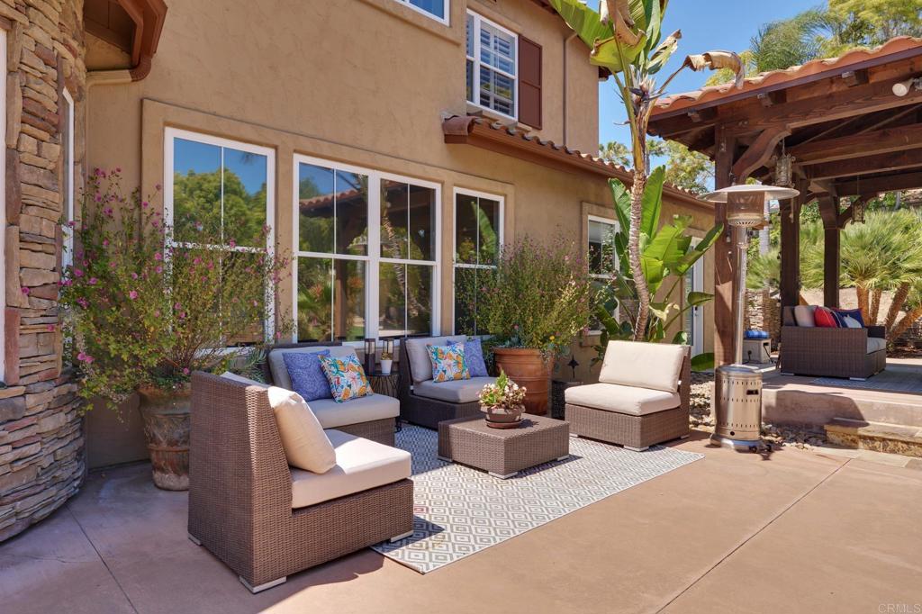 835 Stratford Knoll Encinitas, CA 92024 - Photo 8 of 31 a view of a patio with couches and a table and chairs