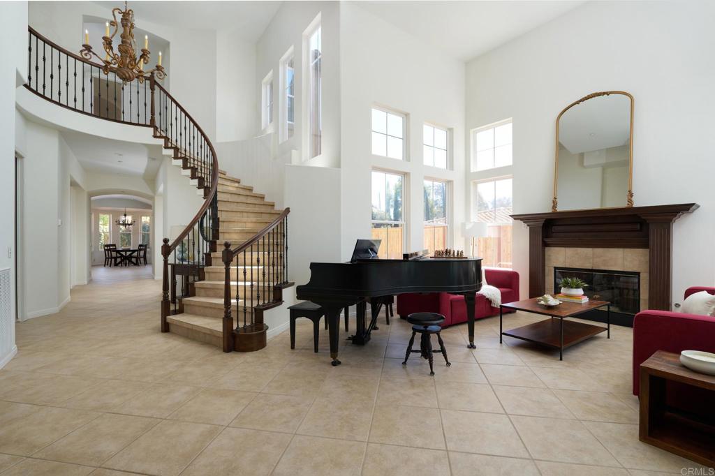 835 Stratford Knoll Encinitas, CA 92024 - Photo 10 of 31 a living room with furniture a fireplace and a floor to ceiling window