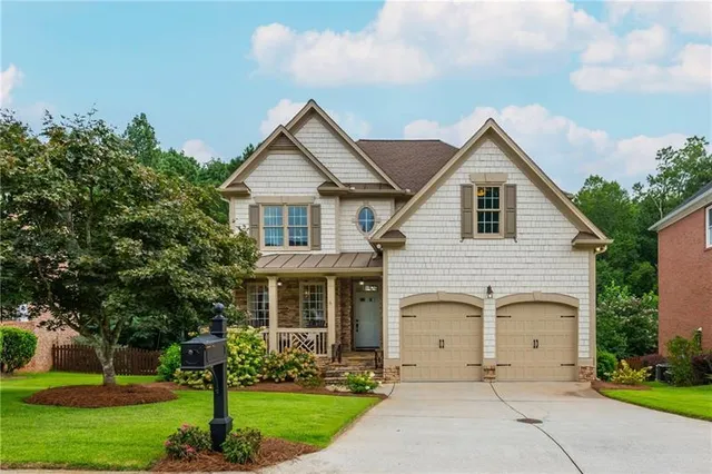 a view of house with yard and green space