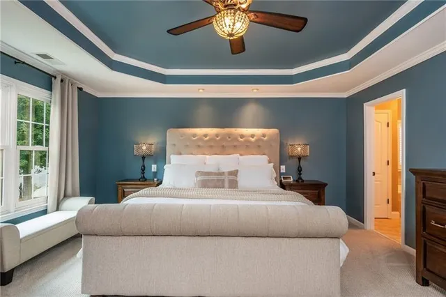 a spacious bedroom with a bed and a chandelier