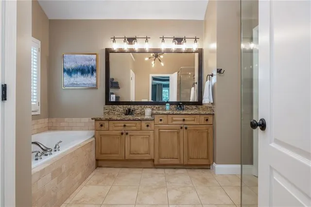 a en suite bathroom with a double vanity sink and a mirror