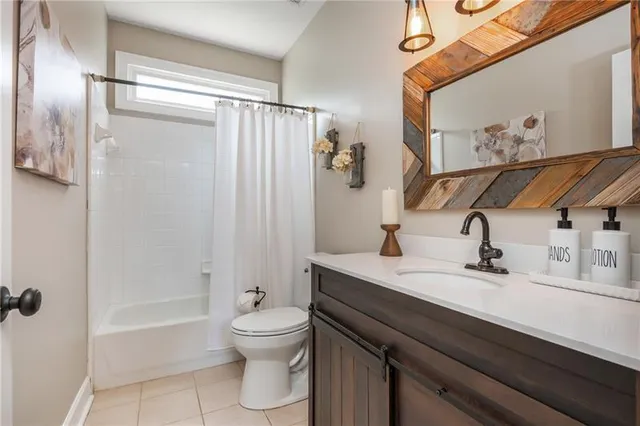 a bathroom with a sink mirror and toilet