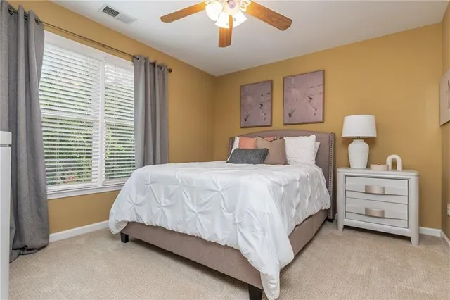 a bedroom with furniture and a ceiling fan