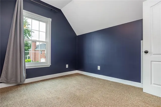 a living room with furniture a flat screen tv and a large window