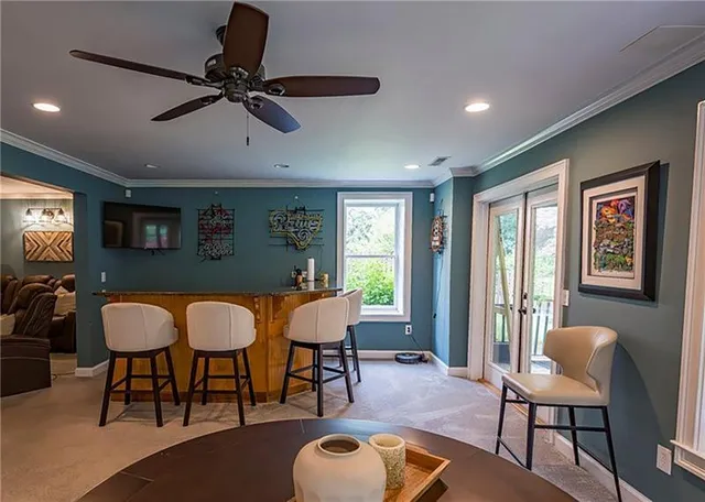 a view of a house with a yard and potted plants