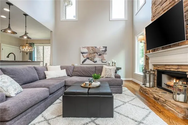 a living room with furniture and a large mirror