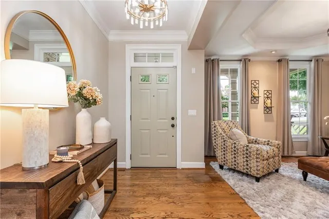a very nice looking kitchen with granite countertop a stove a sink a dining table and chairs