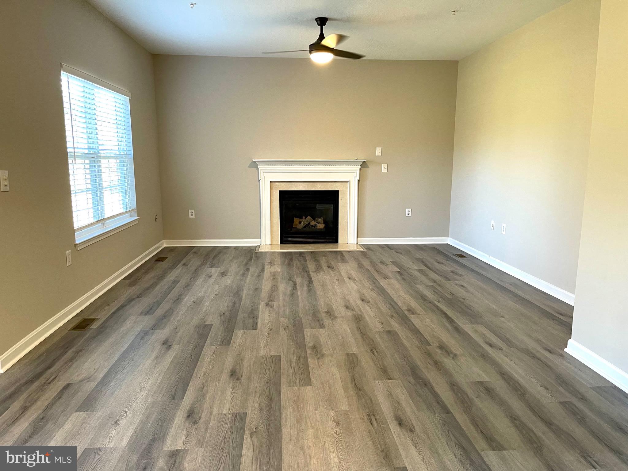 12003 Piscataway Road Clinton, MD 20735 - Photo 11 of 68 wooden floor fireplace and window in an empty room