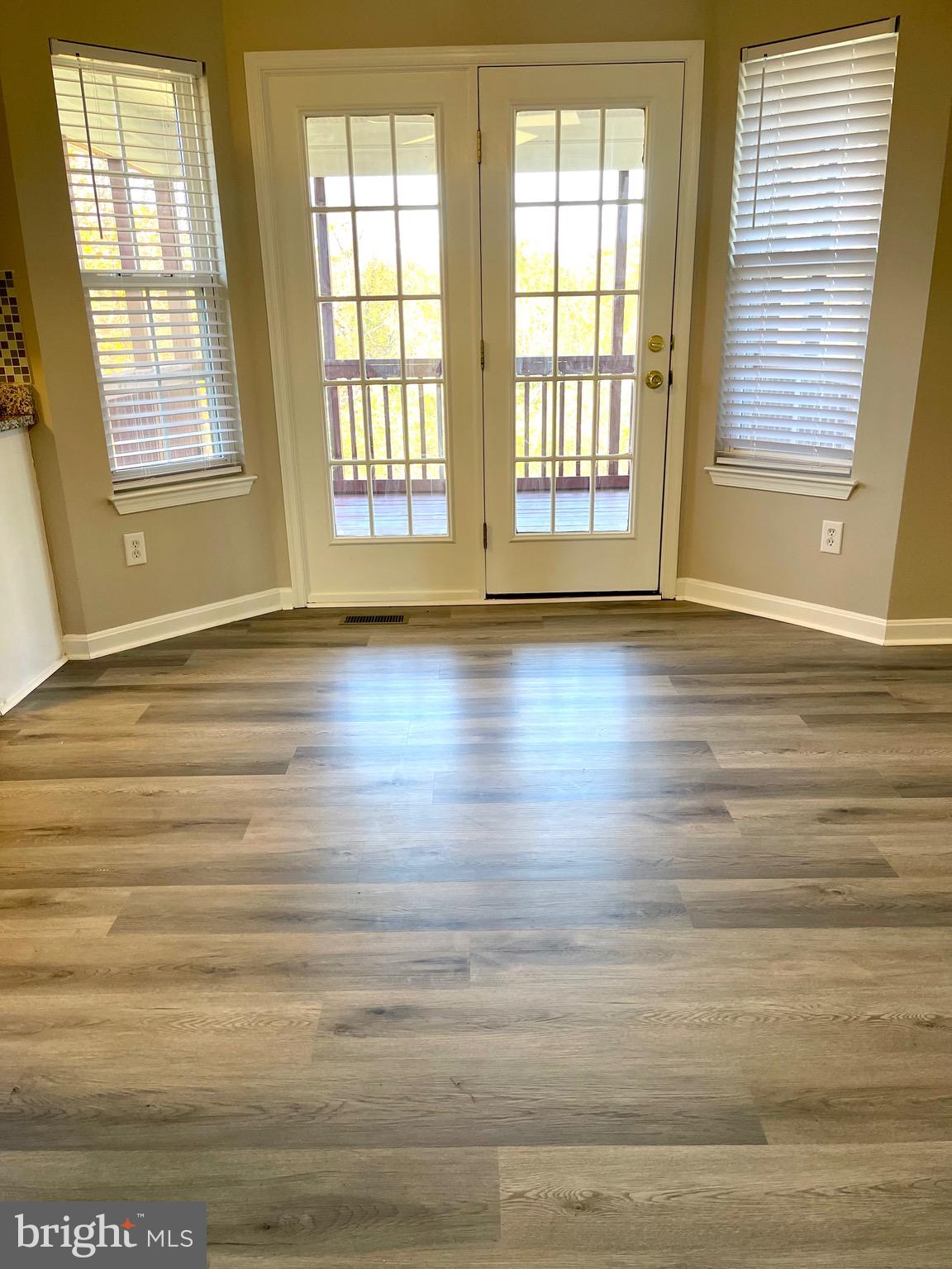 12003 Piscataway Road Clinton, MD 20735 - Photo 14 of 68 a view of an empty room with wooden floor and a window